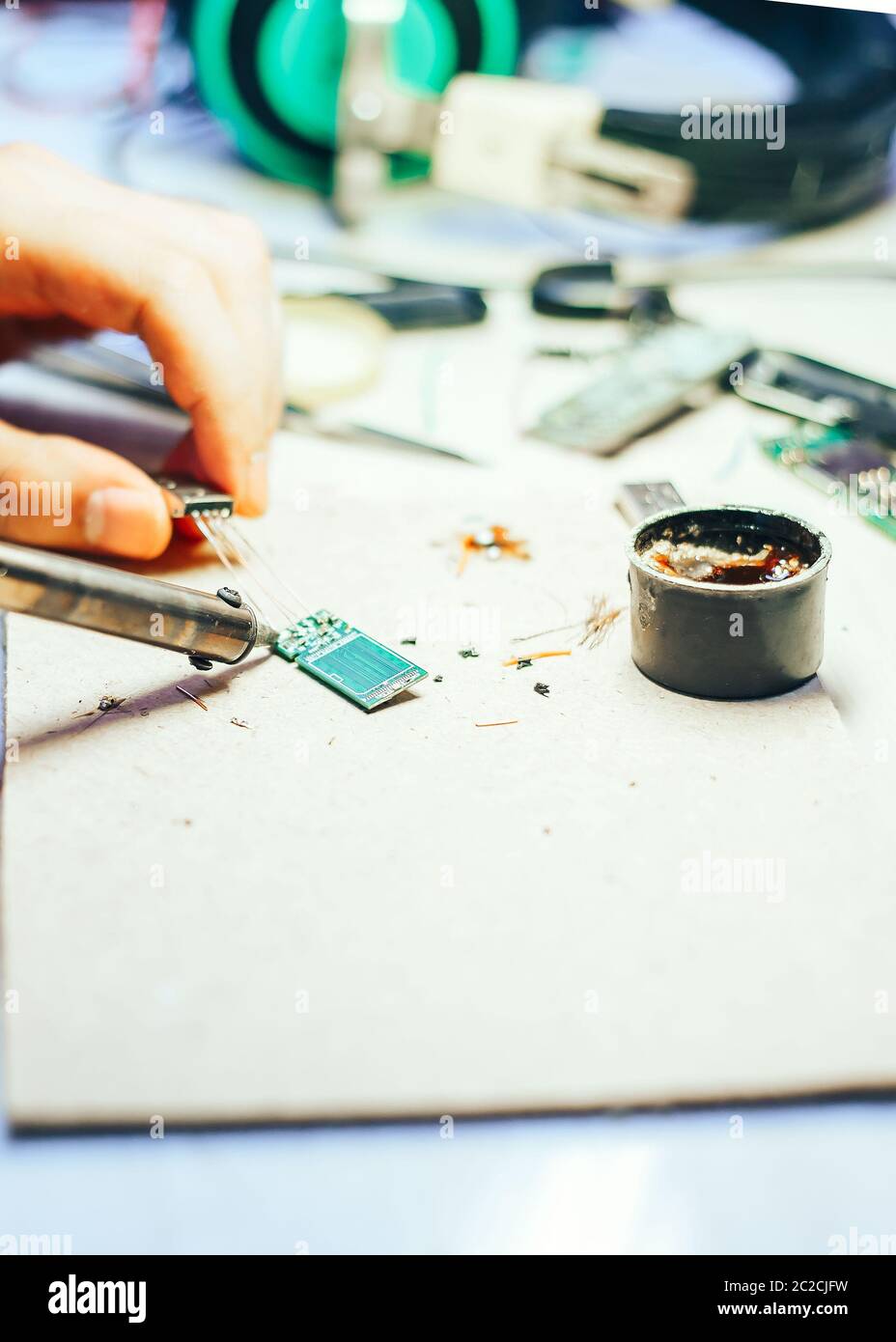Image of engineer with soldering iron repairing mechanism Stock Photo