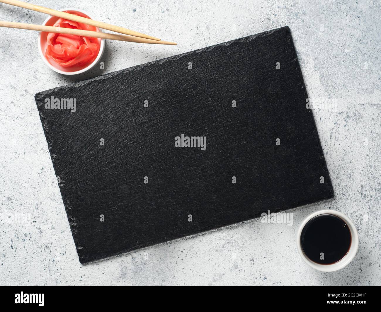 Empty slate, chopsticks, soy sauce, pickled ginger Stock Photo