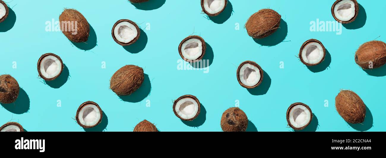 Coconuts half on blue background, banner Stock Photo
