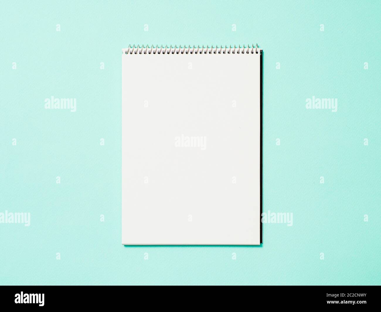Blank paper notebook on blue background Stock Photo