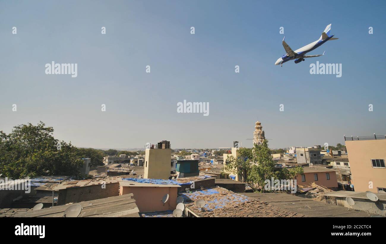 The plane lands low over the slums of the city of Mumbai. Stock Photo