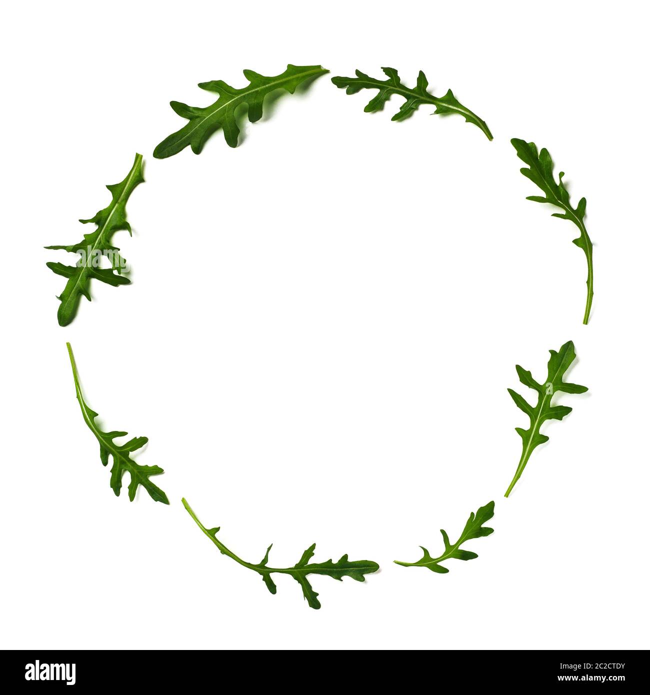 Pattern from arugula in round frame isolated Stock Photo