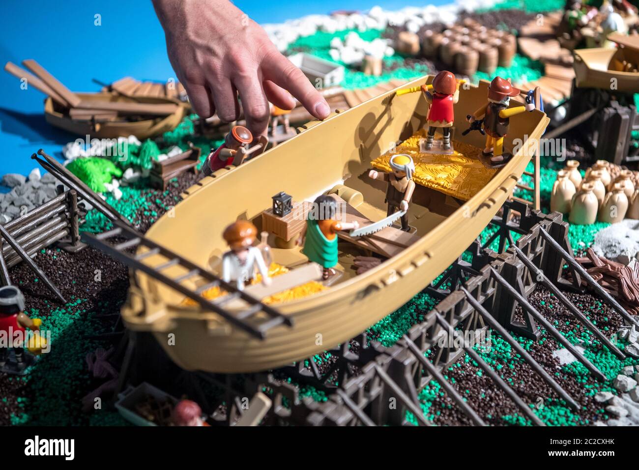 17 June 2020, Bremen, Bremerhaven: Oliver Schaffer, artist and Playmobil  collector, shows his work in the special exhibition "Cog meets Playmobil".  Staged Playmobil figures tell the story of the Bremen cog from