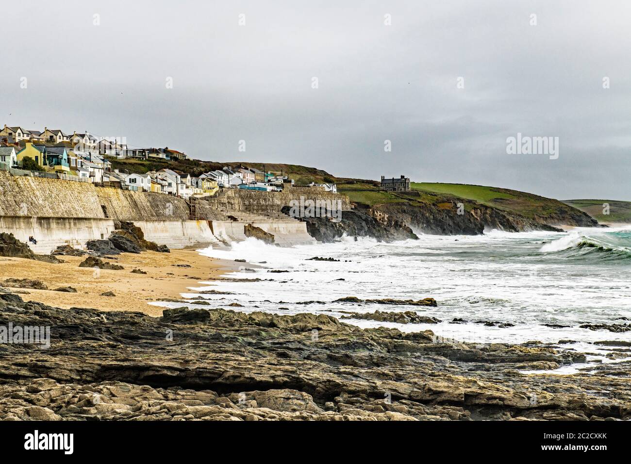 Porthleven Beach on a cold and windswept day in April with wind blowing the waves right up the beach. Porthleven is on the south Cornwall Coast. Stock Photo