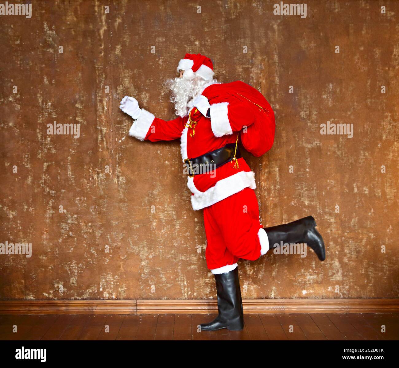 Santa Using A Walker Santa Claus walking with the bag of the presents Stock Photo - Alamy