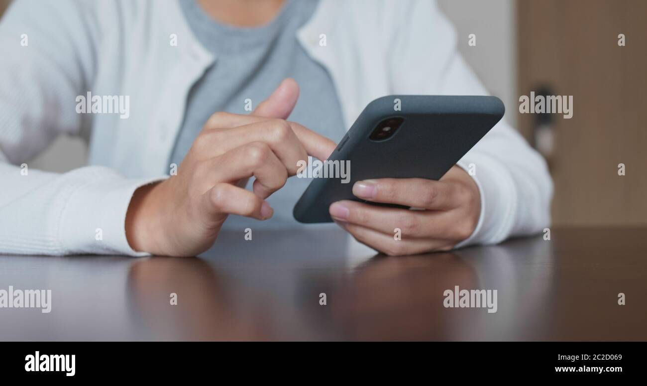 Using Phones In House Woman use of smart phone at home Stock Photo - Alamy