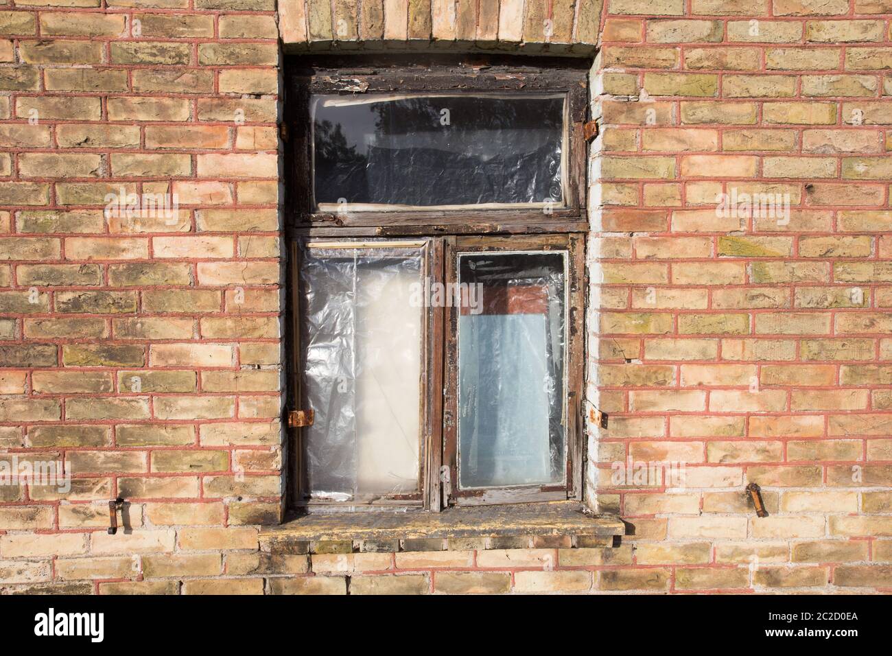 old broken closed window on the brick wall Stock Photo