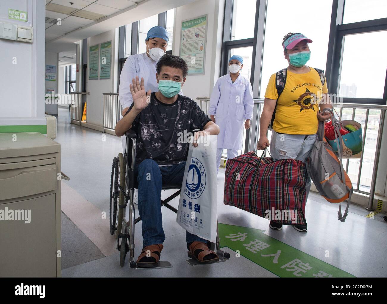 (200617) -- WUHAN, June 17, 2020 (Xinhua) -- Hu Dingjiang waves goodbye at Wuhan Pulmonary Hospital in Wuhan, central China's Hubei Province, June 17, 2020. Hu Dingjiang, 40, a recovered COVID-19 patient, was discharged from Wuhan Pulmonary Hospital on Wednesday after receiving medical treatment and rehabilitation training for more than 100 days. He was diagnosed with the disease in early February, and was hospitalized in the ICU ward as one of the 81 severe COVID-19 cases in the hospital. The functions of his lungs recovered on April 5 with 40 days of extracorporeal membrane oxygenation (ECMO Stock Photo