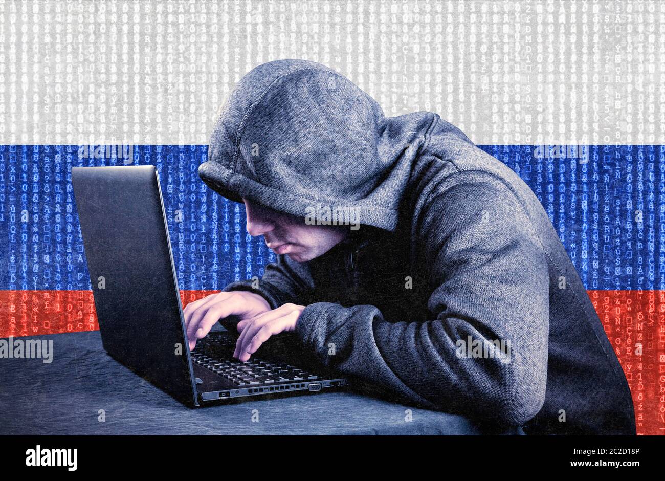 Russian hooded computer hacker with laptop Stock Photo