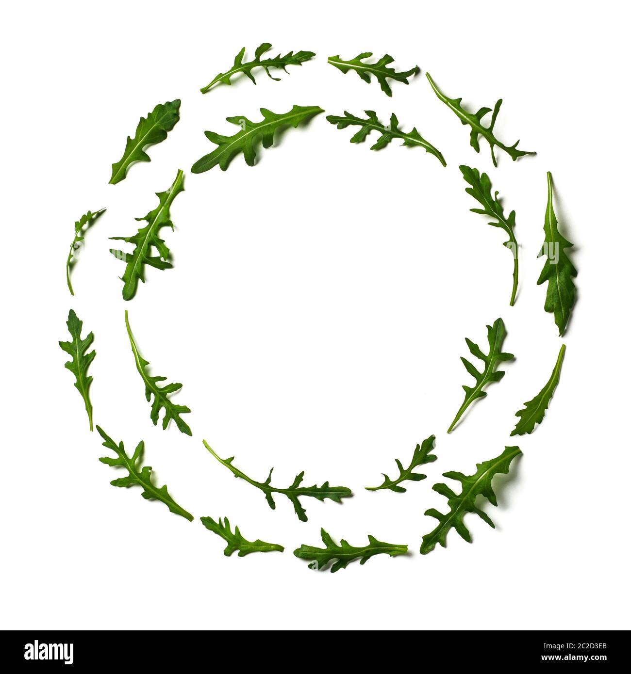 Pattern from arugula in round frame isolated Stock Photo