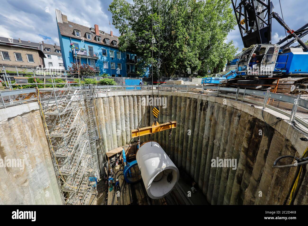 Essen, Ruhr Area, North Rhine-Westphalia, Germany - Construction of a new sewer on the Berne, lifting a sewer pipe in the shaft during tunnel driving, Stock Photo