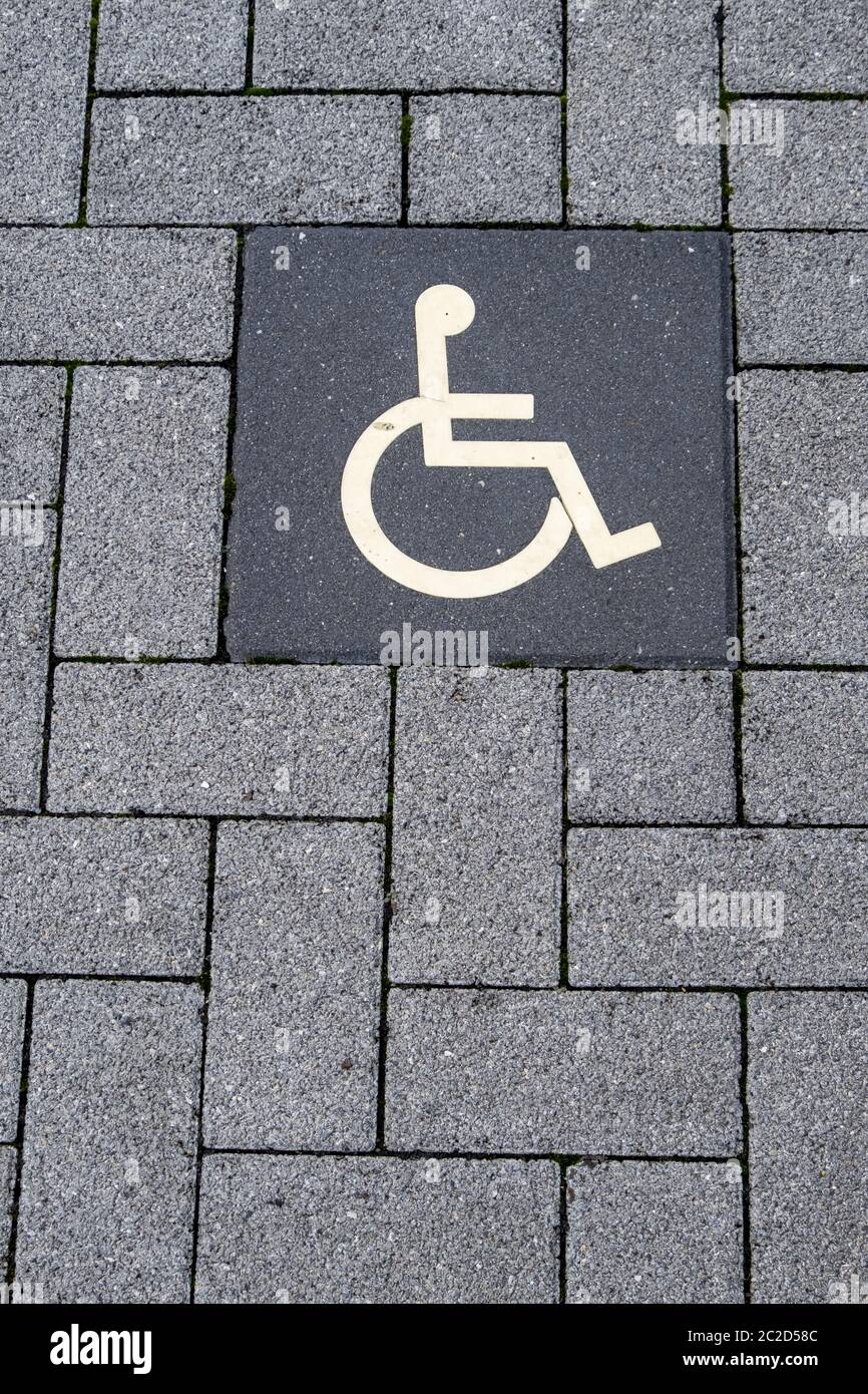 Pictogram disabled parking on paving stones Stock Photo