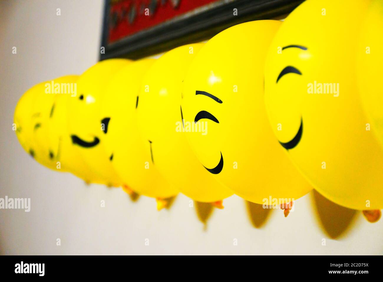 Balloons decoration on wall, emoji faces on balloons Stock Photo