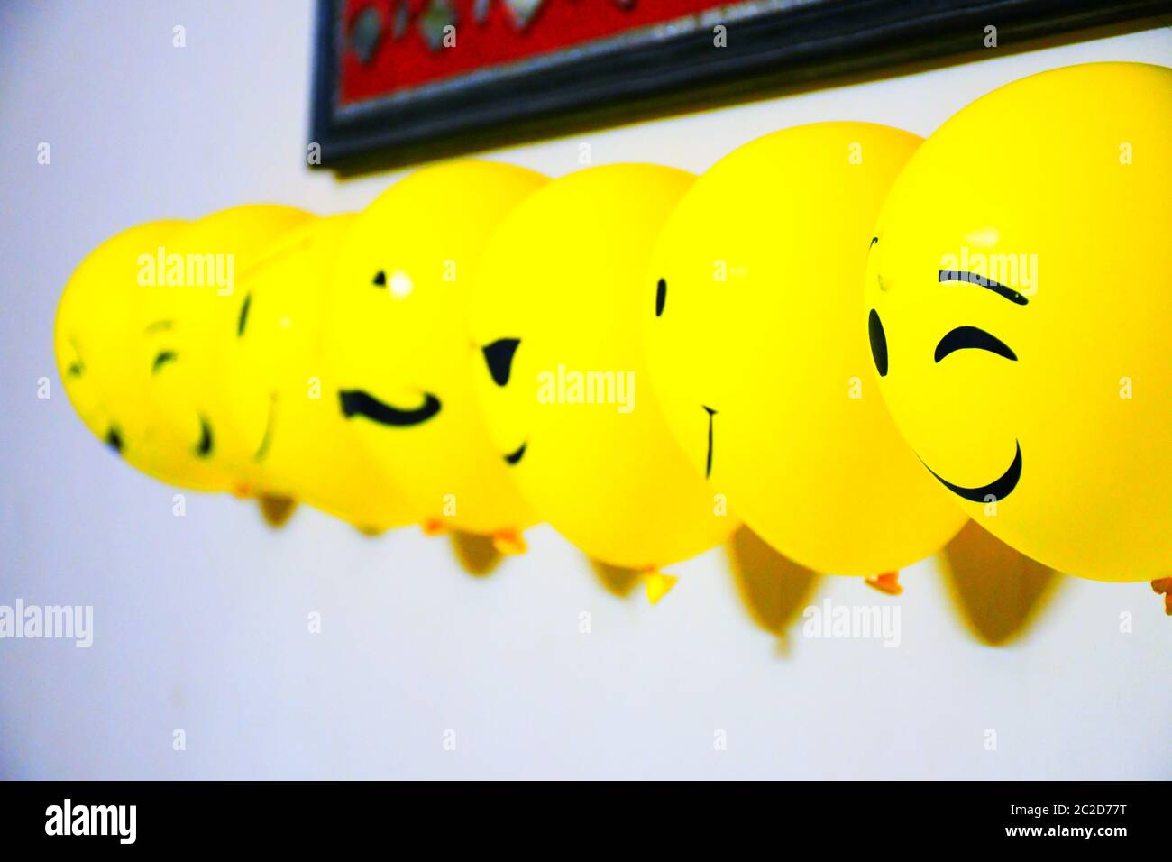 Balloons decoration on wall, emoji faces on balloons Stock Photo