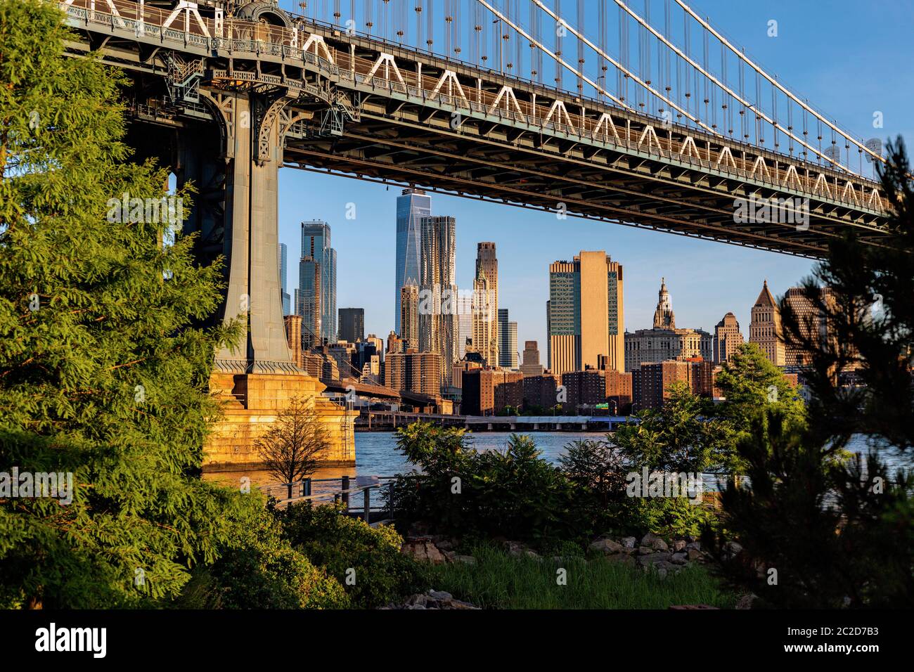 New York City / USA - JUN 25 2018: Lower Manhattan skyline at sunrise view from Brooklyn Bridge Park Stock Photo