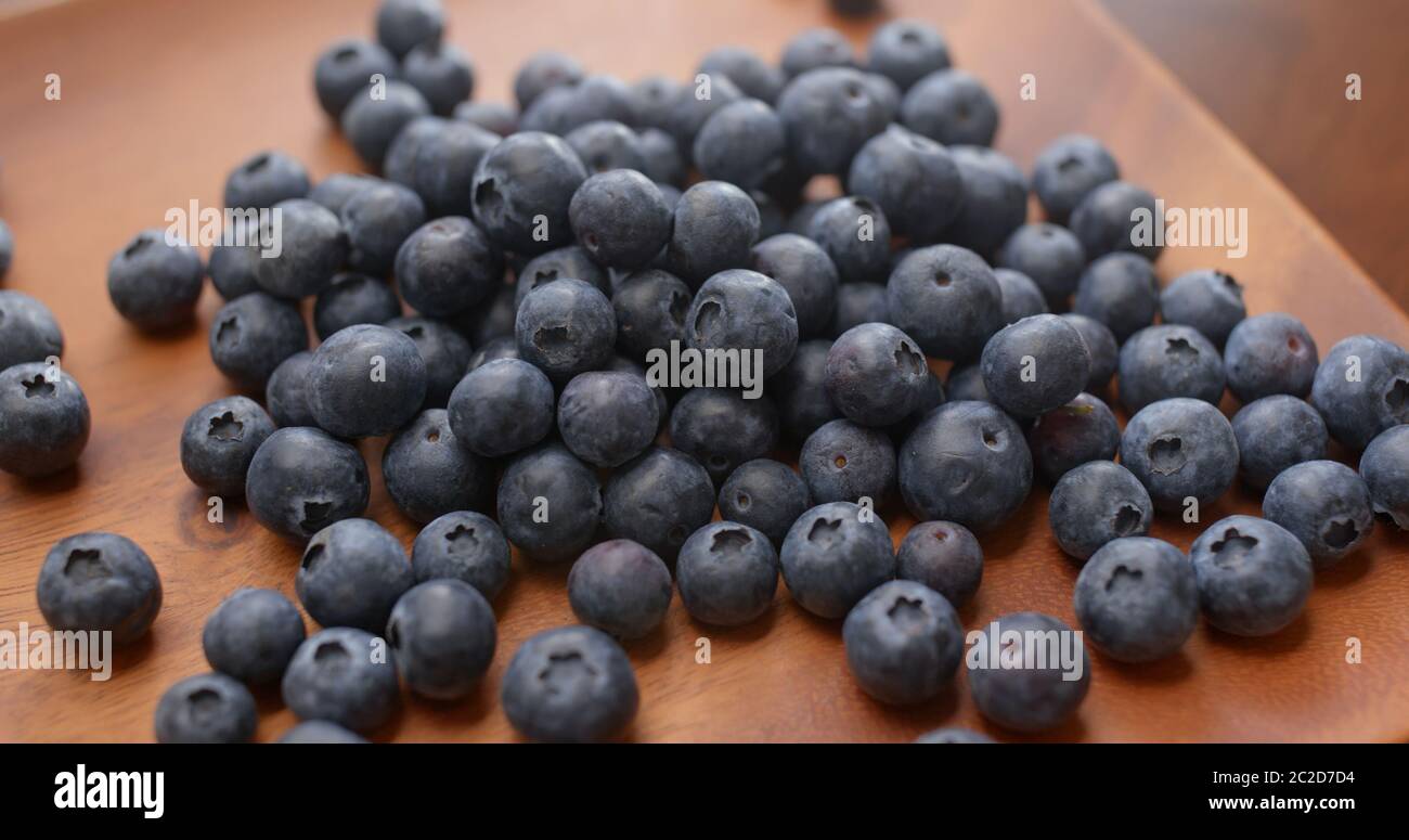 Stack of blueberry on the wooden plate Stock Photo - Alamy