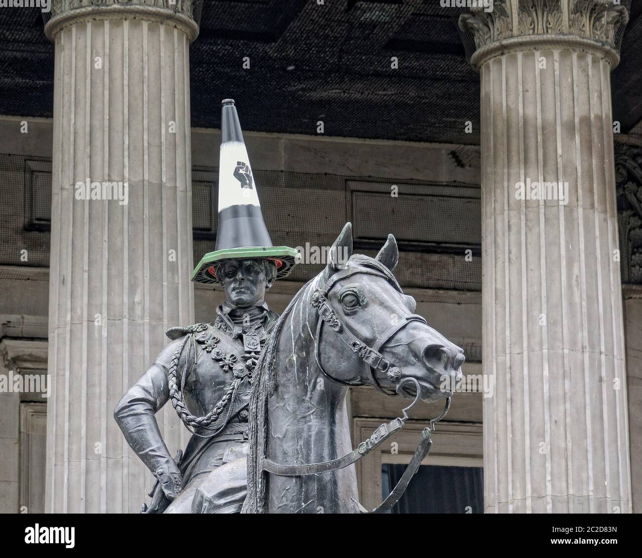 Glasgow, Scotland, UK 17th June, 2020: BLM ironically one of the targeted statues of the warmonger duke of weellington shows support as the iconic cone head is given a twist, in city centre. Credit: Gerard Ferry/Alamy Live News Stock Photo