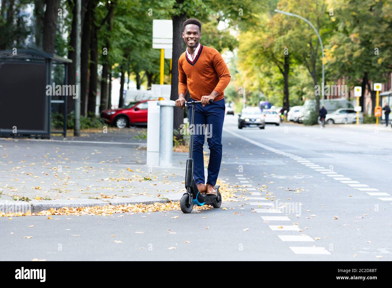 Young African Man Riding An Electric Scooter Stock Photo