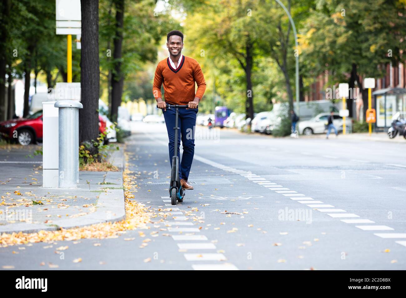 Young African Man Riding An Electric Scooter Stock Photo