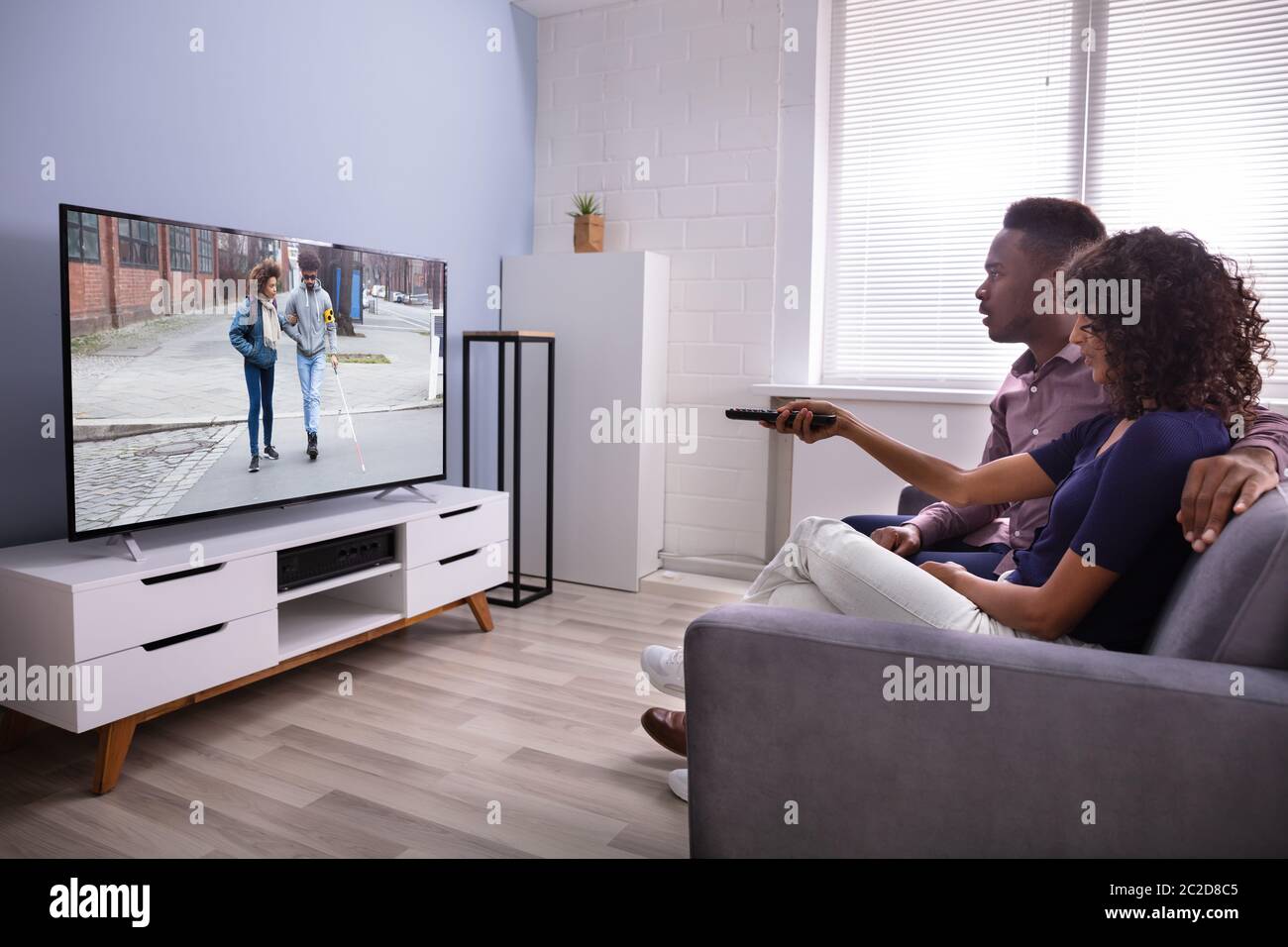 Affectionate Young Family Watching TV At Home Stock Photo Alamy