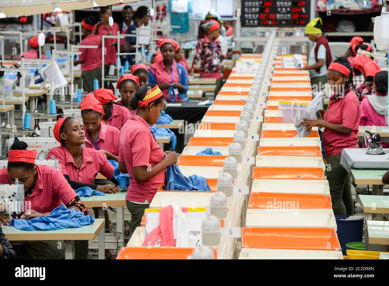 ETHIOPIA , Southern Nations, Hawassa or Awasa, Hawassa Industrial Park, chinese-built for the ethiopian government to attract foreign investors with low rent and tax free to establish a textile industry and create thousands of new jobs, taiwanese company Everest Textile Co. Ltd.produces textiles from synthetic fabric for export, women at sewing machine in production line and Performance and efficiency display Stock Photo