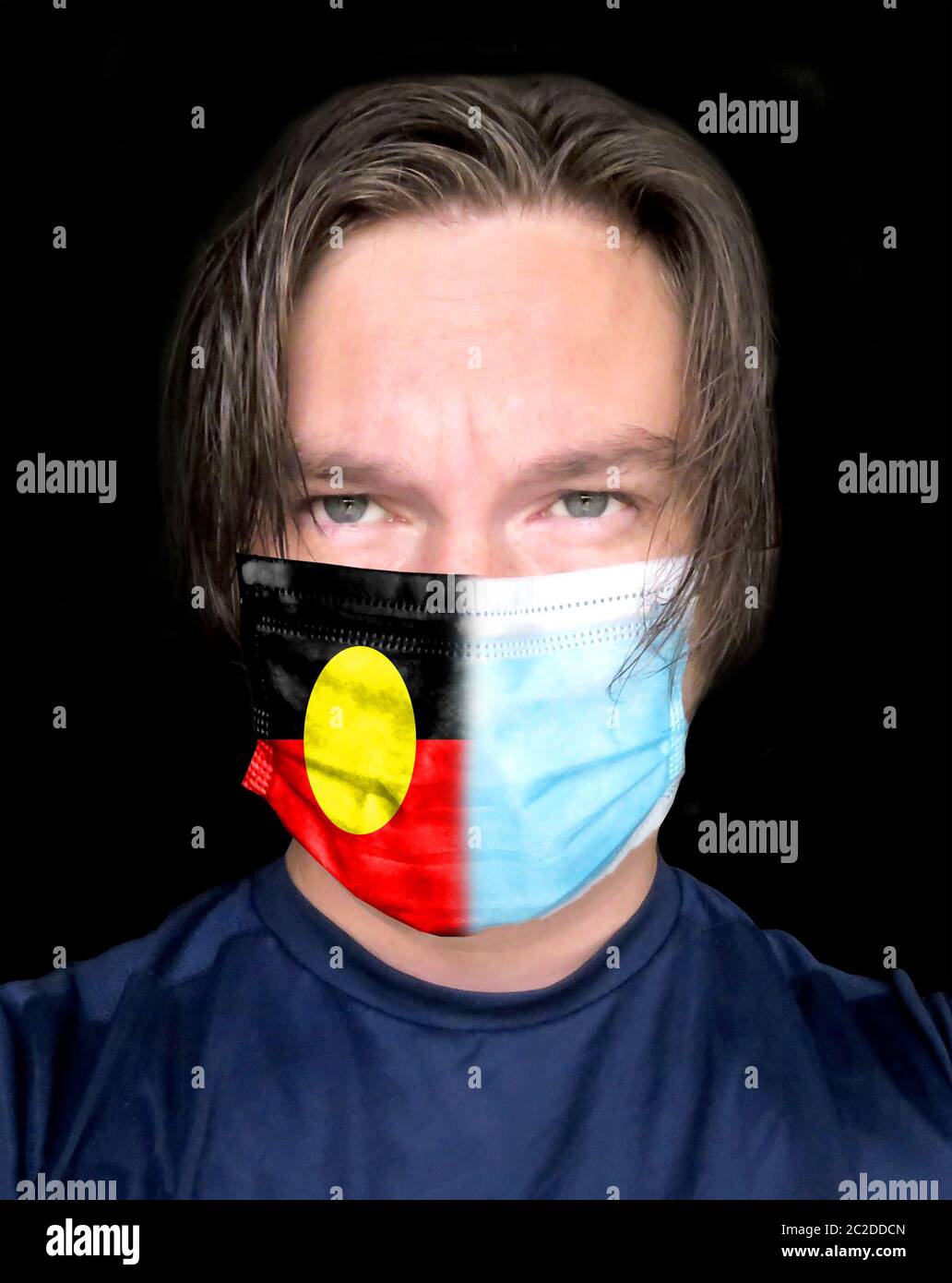 Man in medical mask with Australian Aboriginal flag on the mask. Stock Photo
