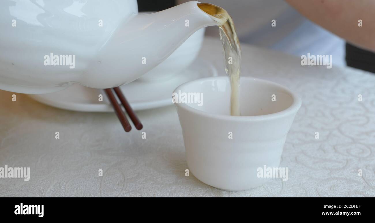 Pouring hot tea in chinese restaurant Stock Photo