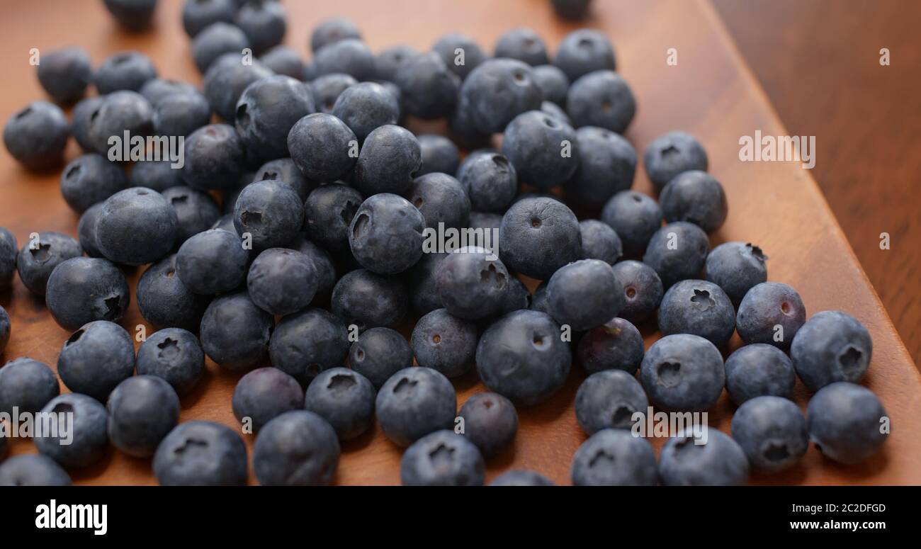 Stack of blueberry on the wooden plate Stock Photo - Alamy