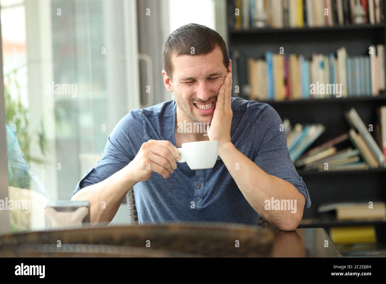 Fronf view portrait of a man complaining suffering tooth ache after