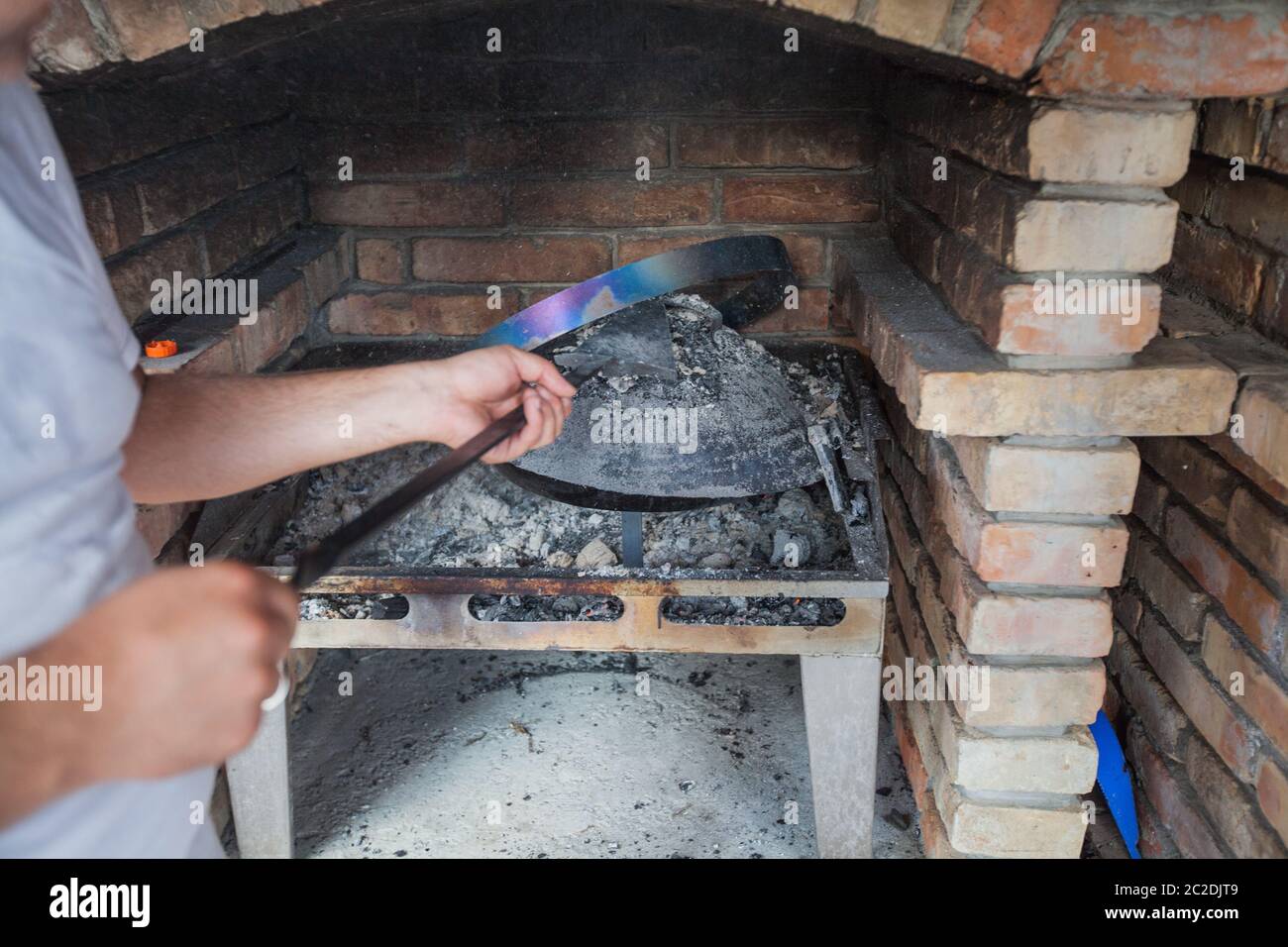 Traditional Balkans Food Preparation , cooking under the lid covering