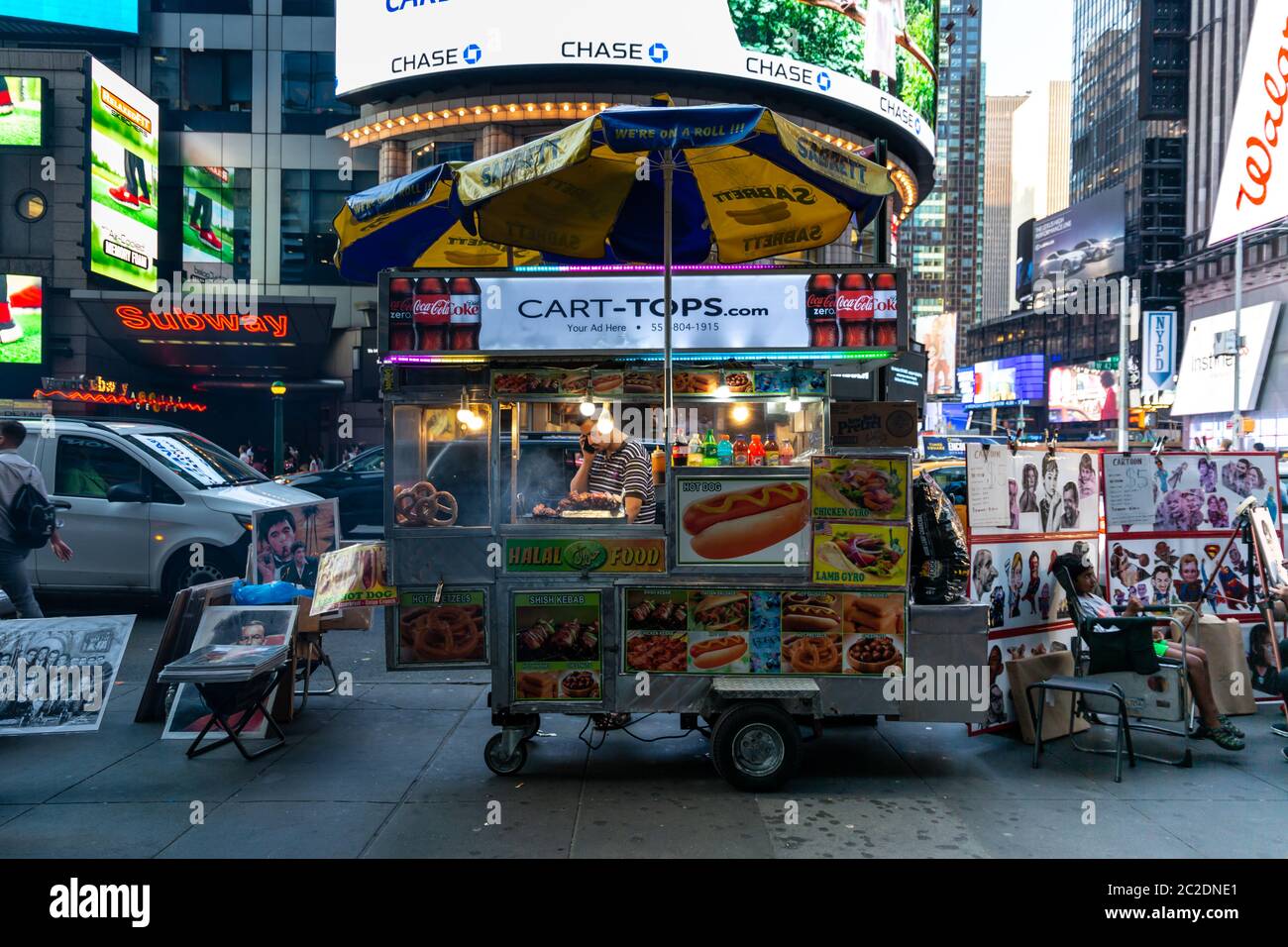 New York City / USA - JUL 13 2018: Times Square street food cart at rush hour in midtown Manhattan Stock Photo