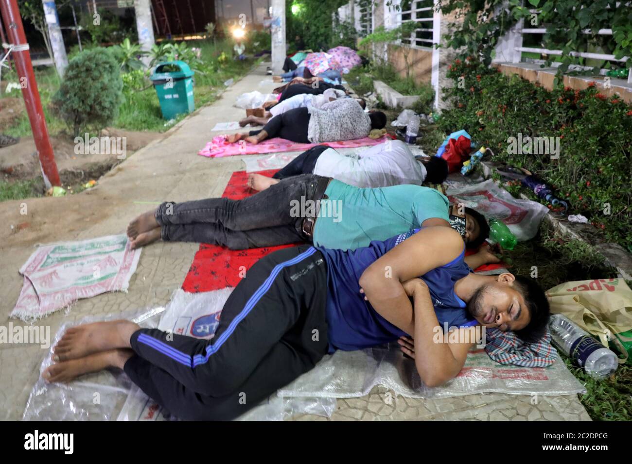 Gazipur, Bangladesh - June 16, 2020: Patients of garment worker with COVID-19 symptoms lie in front of Sheikh Fazilatunnesa Mujib Memorial KPJ Special Stock Photo
