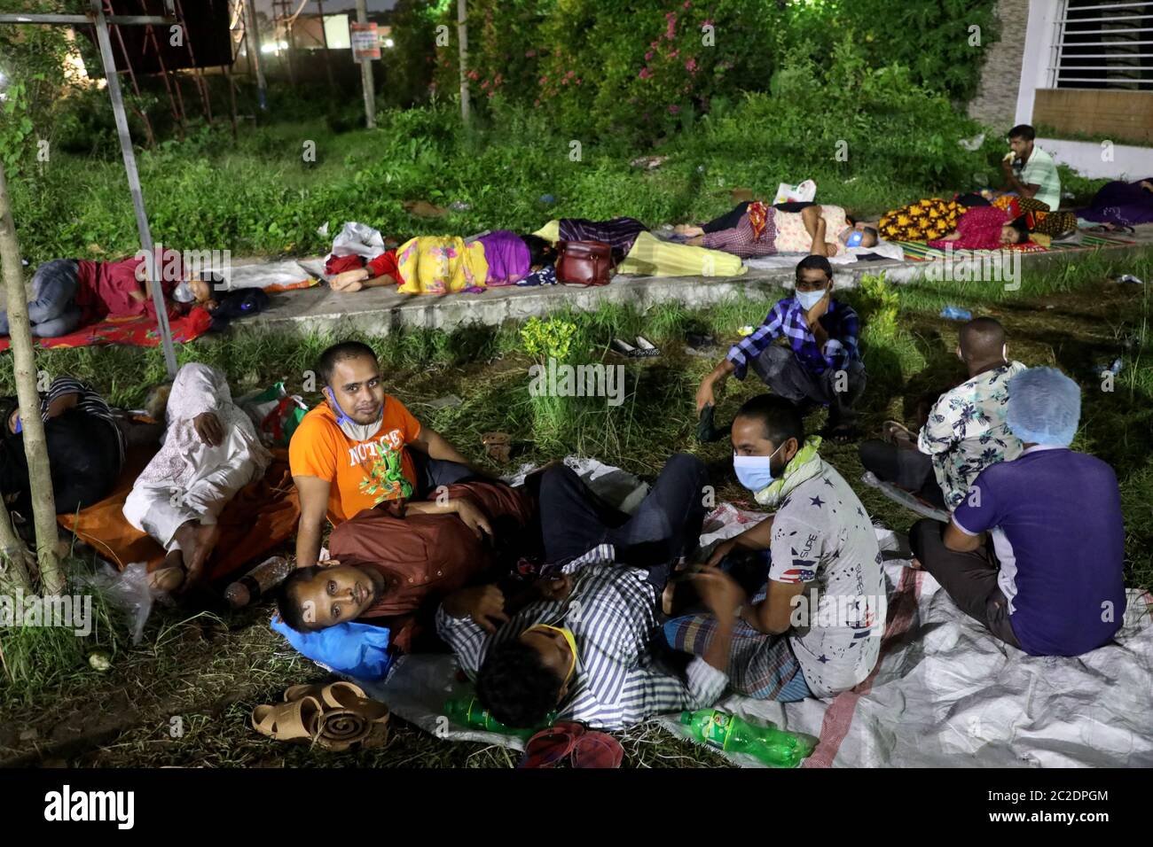 Gazipur, Bangladesh - June 16, 2020: Patients of garment worker with COVID-19 symptoms lie in front of Sheikh Fazilatunnesa Mujib Memorial KPJ Special Stock Photo