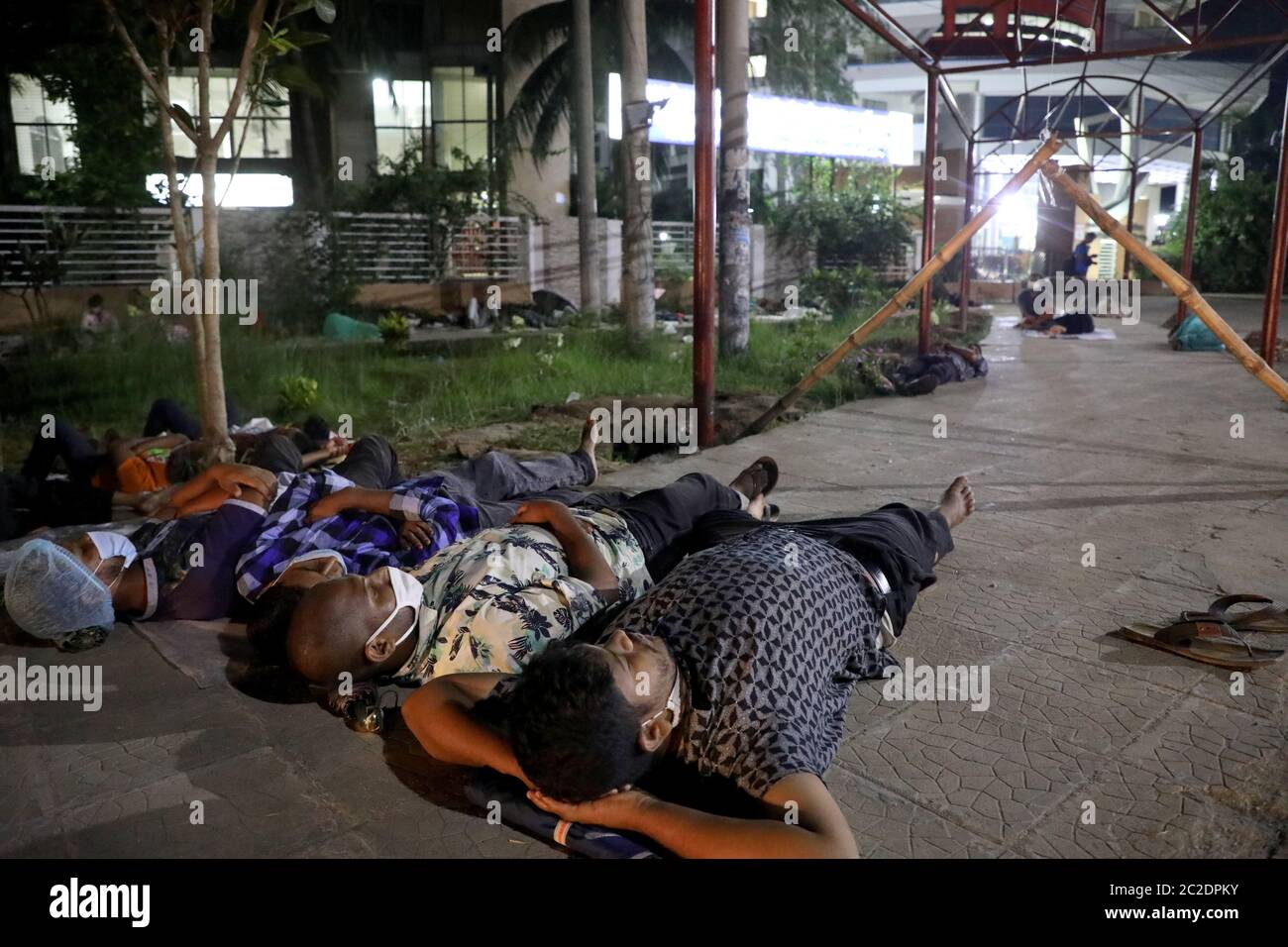 Gazipur, Bangladesh - June 16, 2020: Patients of garment worker with COVID-19 symptoms lie in front of Sheikh Fazilatunnesa Mujib Memorial KPJ Special Stock Photo