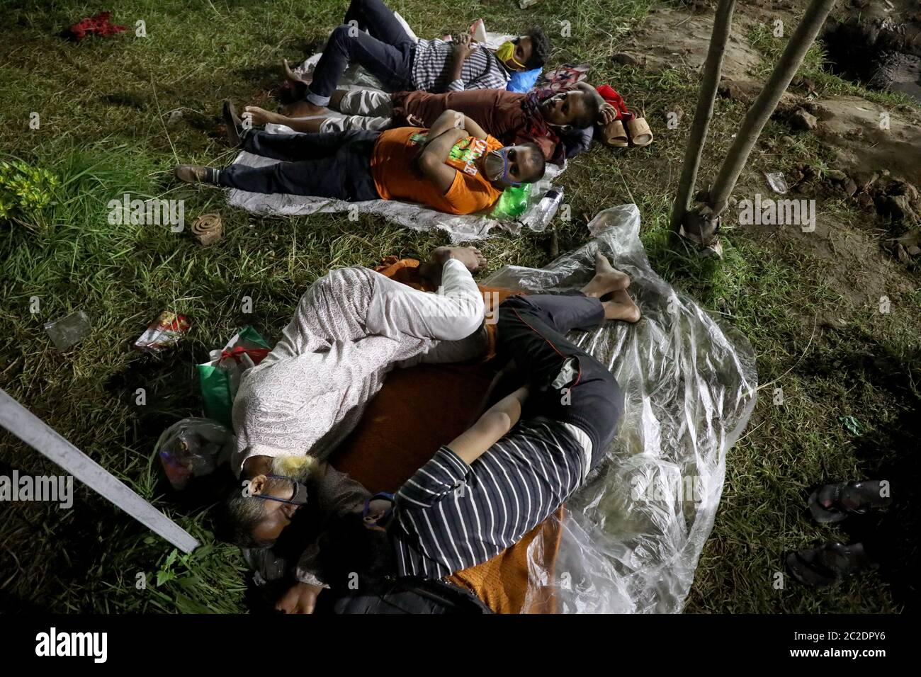 Gazipur, Bangladesh - June 16, 2020: Patients of garment worker with COVID-19 symptoms lie in front of Sheikh Fazilatunnesa Mujib Memorial KPJ Special Stock Photo