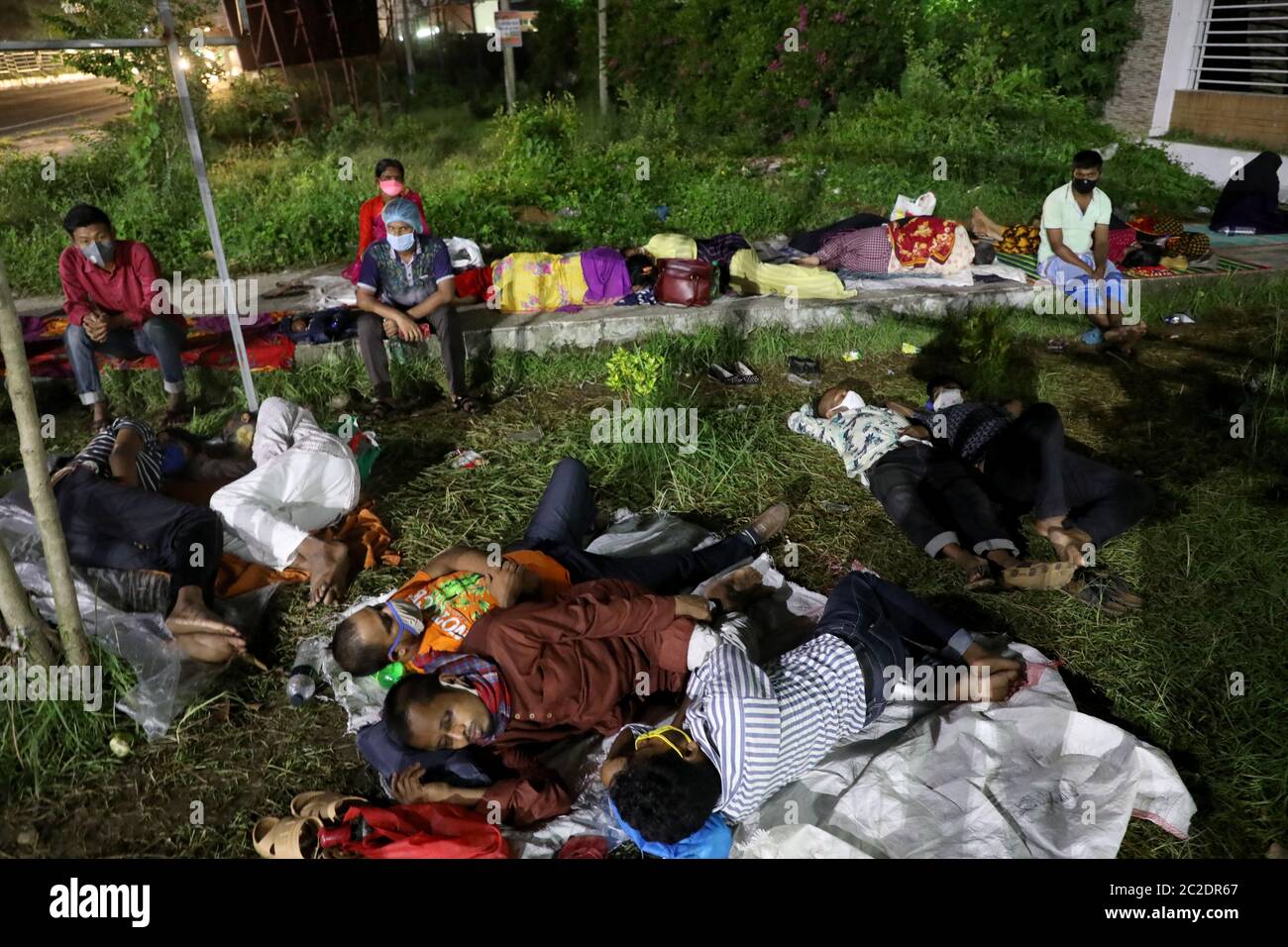 Gazipur, Bangladesh - June 16, 2020: Patients of garment worker with COVID-19 symptoms lie in front of Sheikh Fazilatunnesa Mujib Memorial KPJ Special Stock Photo