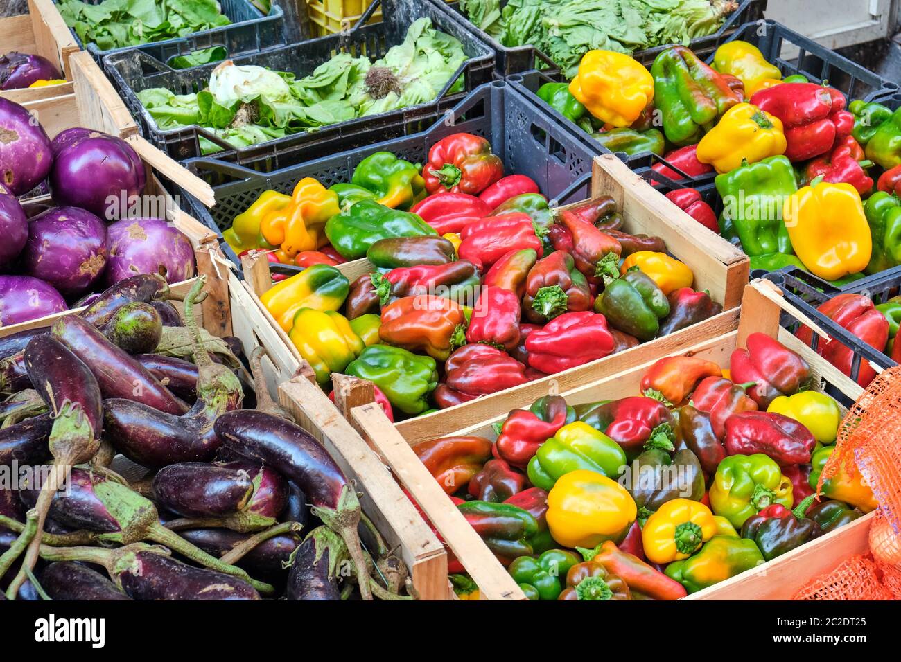 Colorful bell peppers and other vegetables for sale at a market in