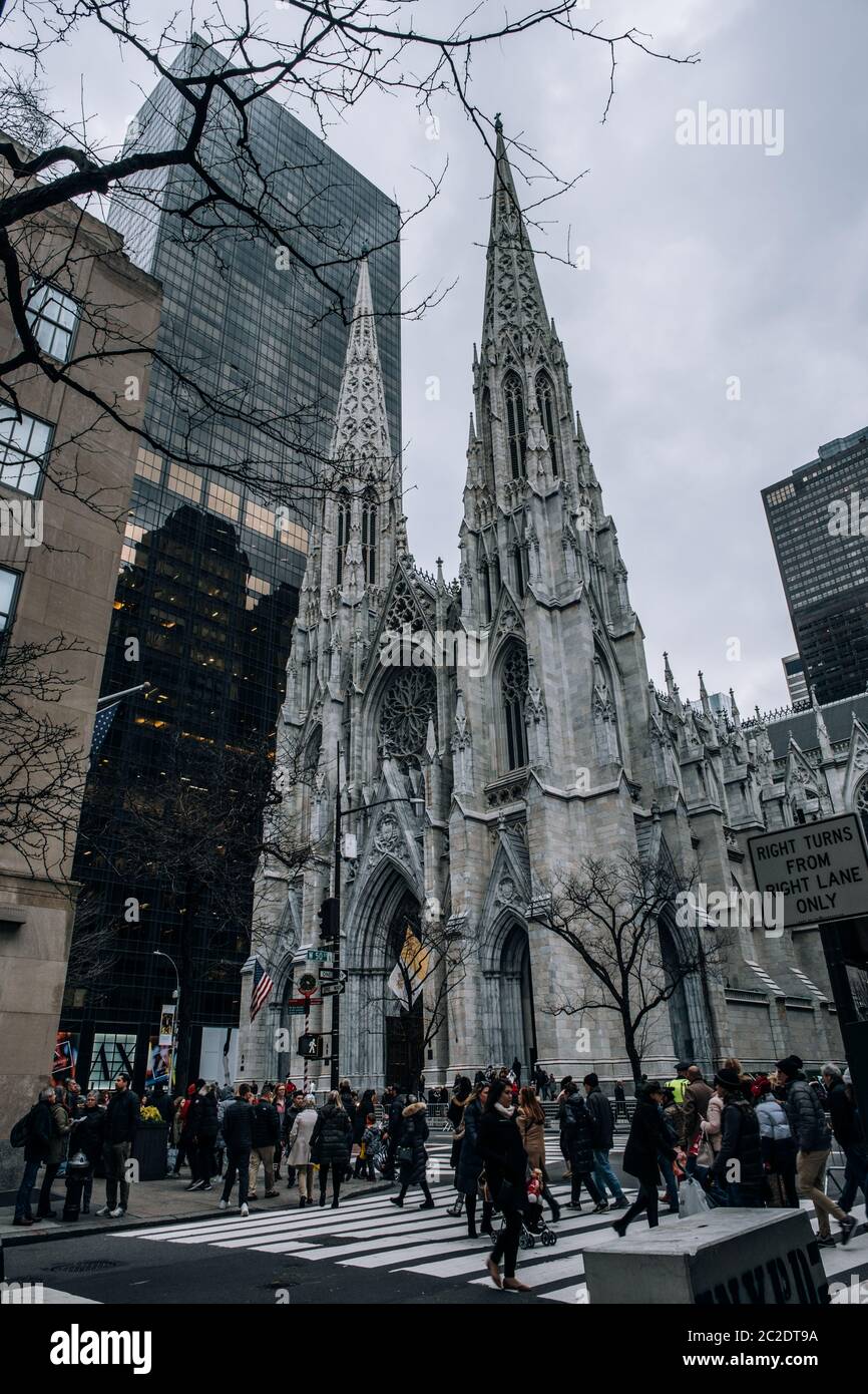 St. Patrick's Cathedral street scene in the Midtown Manhattan. Towering Neo-Gothic church from 1879 with twin spires  storied hi Stock Photo