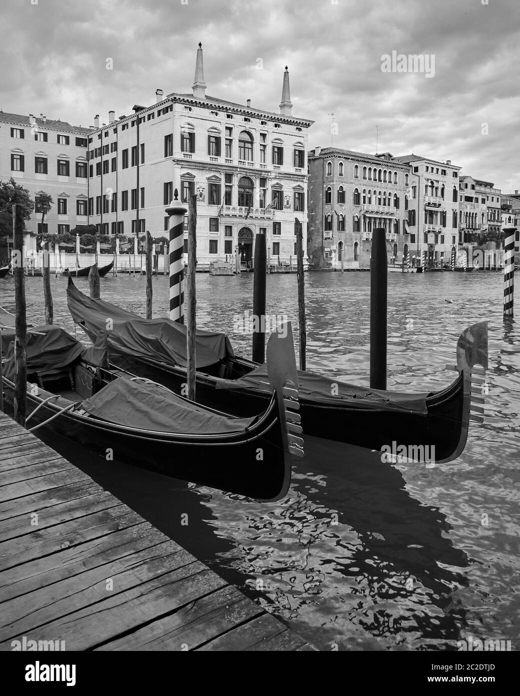 Moored gondolas on the Grand Canal in Venice, Italy. Black and white venetian view Stock Photo