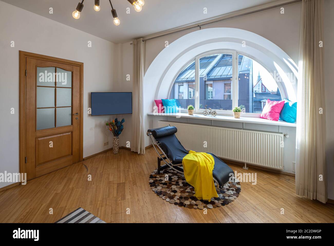 Modern interior of living room in luxury apartment. Semicircle window