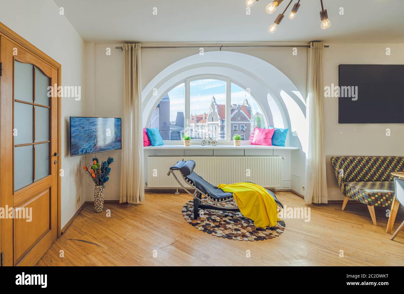 Modern interior of living room in luxury apartment. Semicircle window