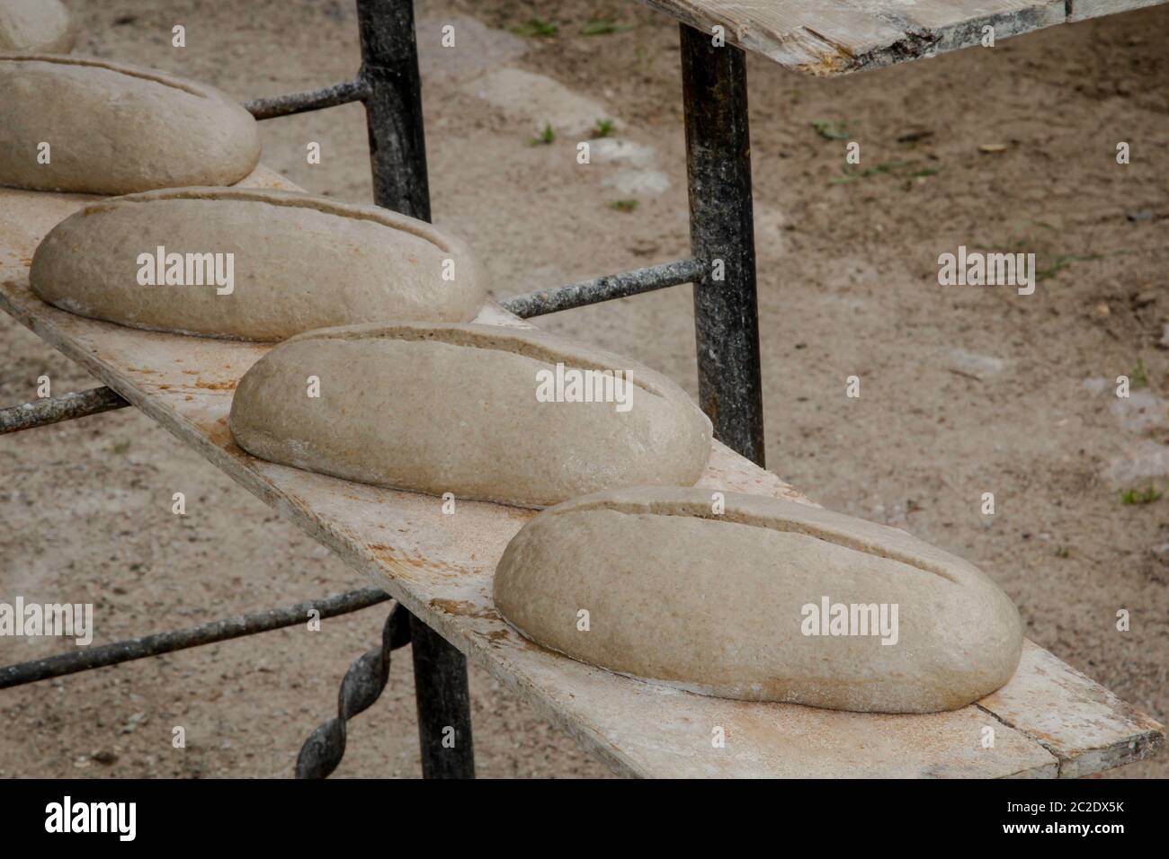 bread loaves lie on a board in front of a bakery Stock Photo