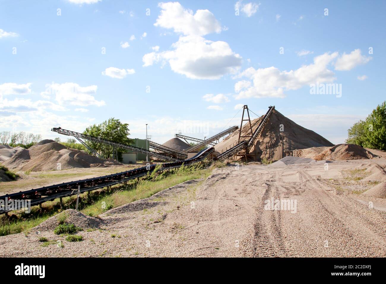 A string of transport belting in a gravel pit for transporting gravel and sand over long distances. Stock Photo