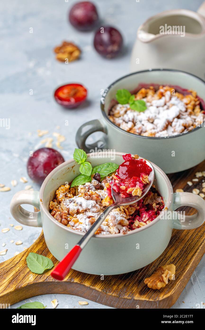 Delicious crumble of red cherry plum and oatmeal. Stock Photo