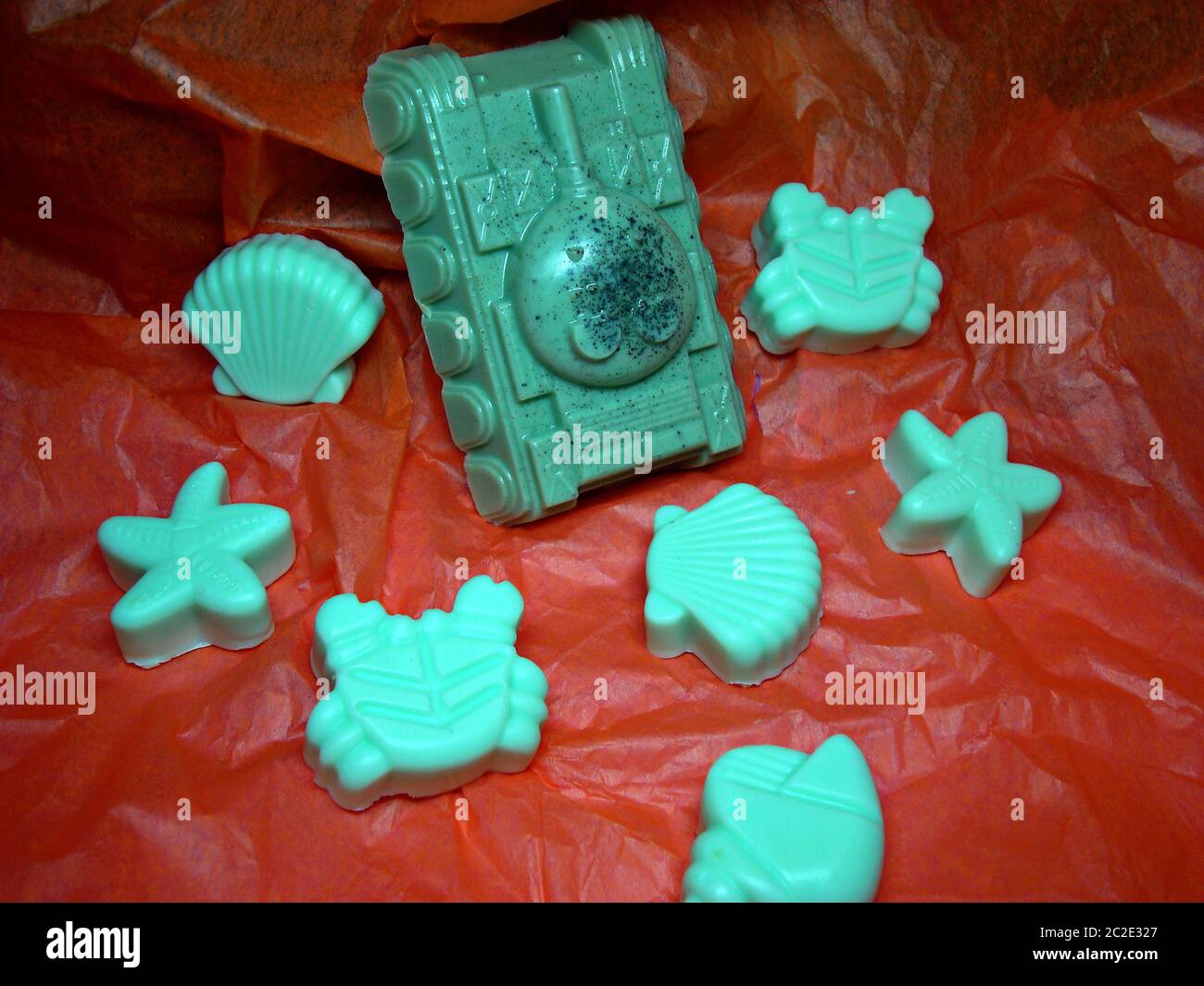 Natural handmade soap. Tank and marine life: crabs, stars, seashells on an orange background. Stock Photo