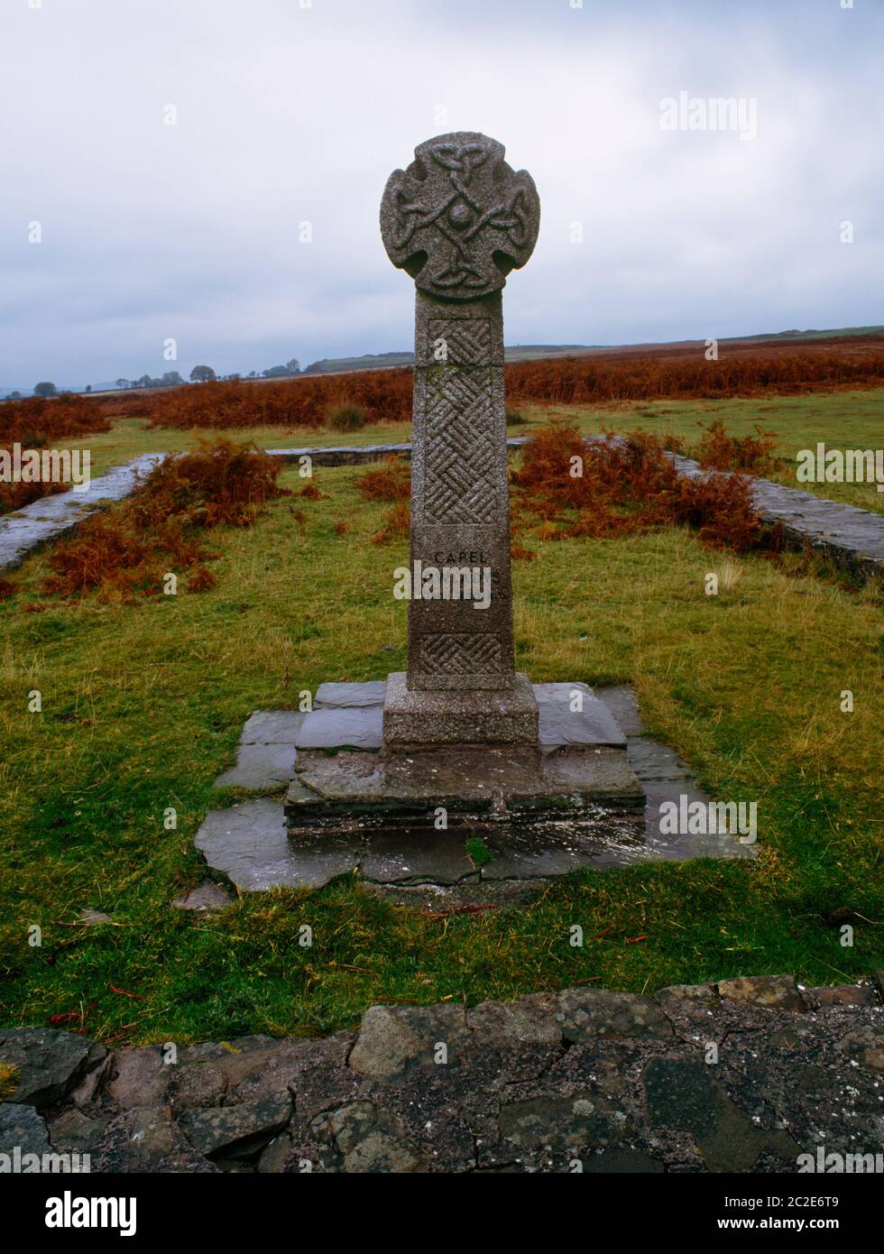 View WNW of a replica Celtic cross on the site of the altar within the outline of Capel Gwladys on Gelligaer Common, Merthyr Tydfil, Wales, UK. Stock Photo
