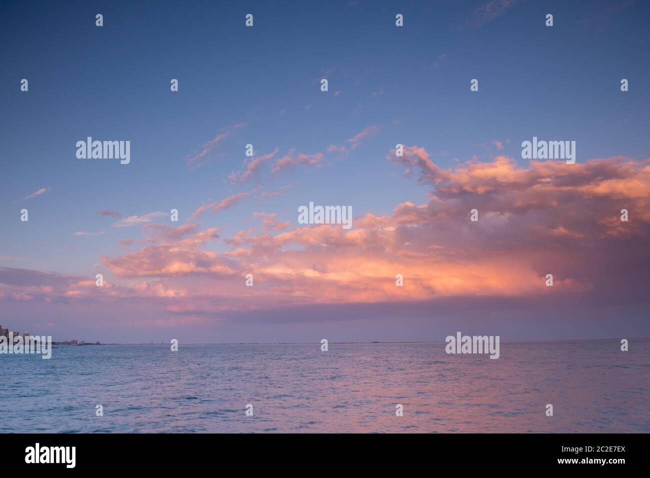Sunset clouds with pink light and blue sky Stock Photo - Alamy
