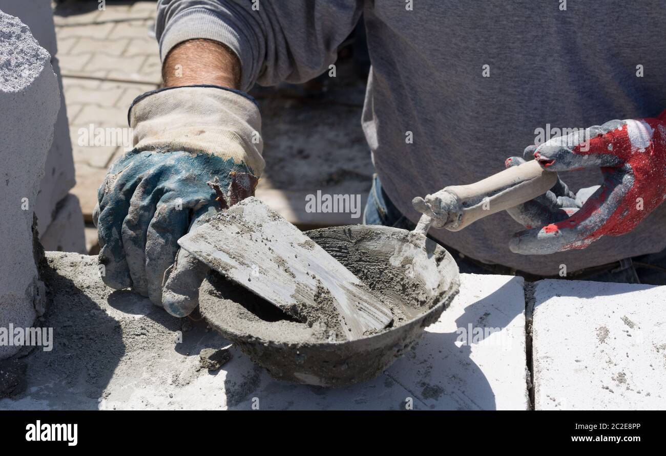 Construction worker hands with trowel and mortar Stock Photo Alamy