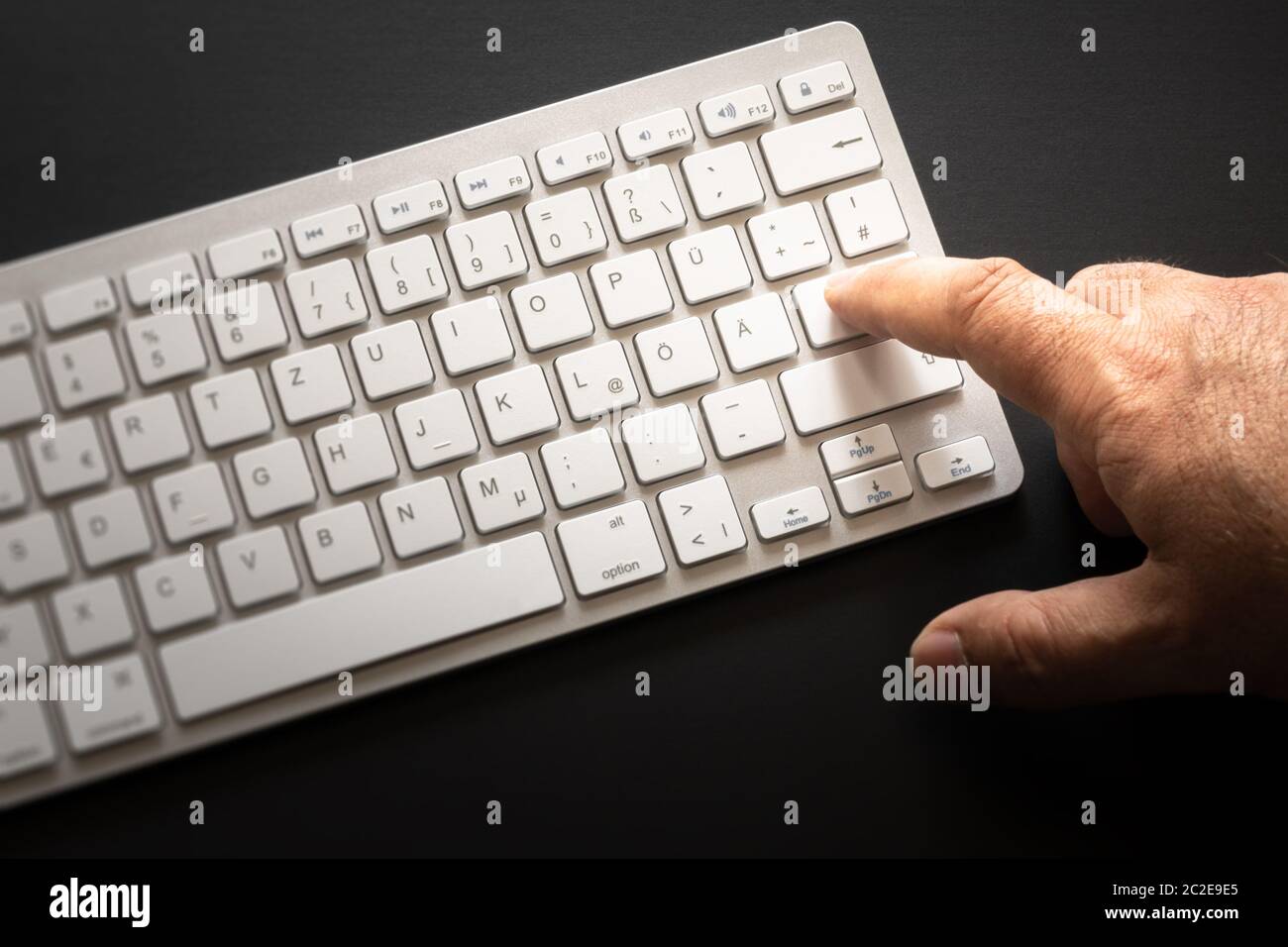 typical computer keyboard with finger on enter Stock Photo