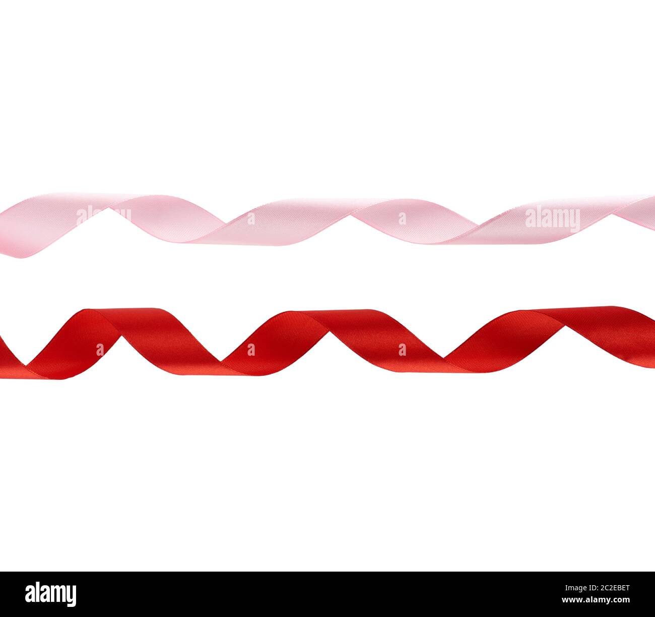 curled red and pink satin ribbons isolated on white background, festive backdrop Stock Photo